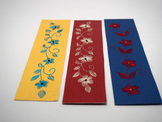 three colorful bookmarks embroidered by hand