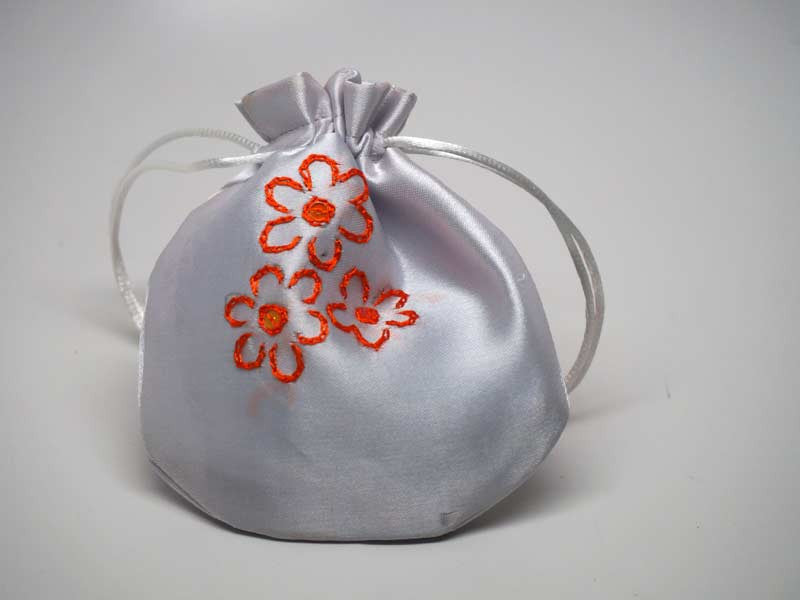 White pouch with handmade embroidered flowers