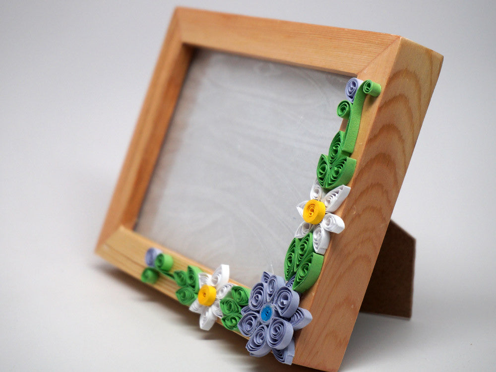 Paper filligree 3D photo frame with handmade flower decorations