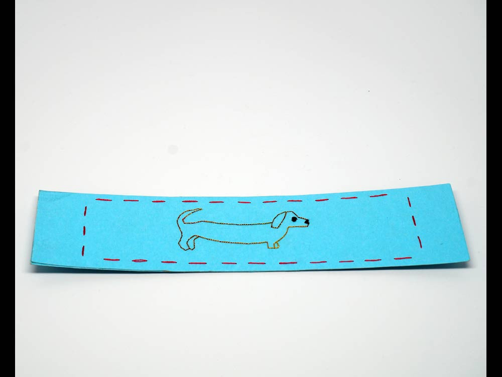Sky-blue bookmark with embroidered dog
