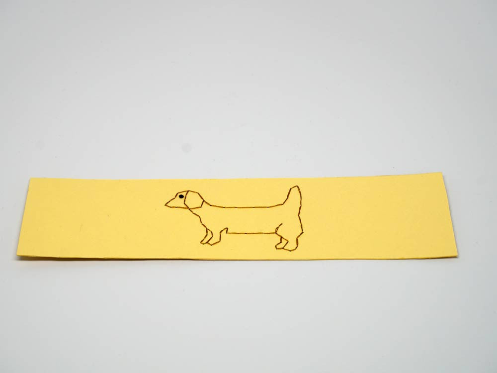 Yellow bookmark with embroidered dog