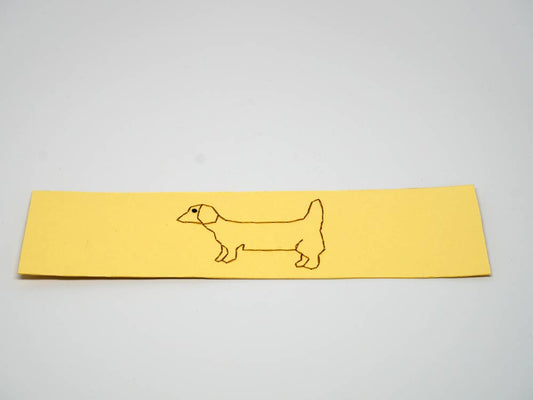 Yellow bookmark with embroidered dog