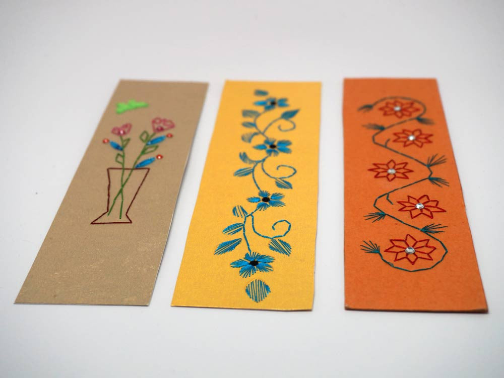 three floral bookmarks embroidered by hand