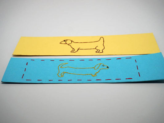 Two embroidered bookmarks with dogs