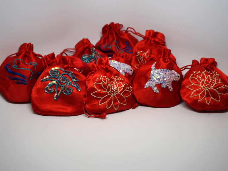 10 assorted red pouches with handmade embroidery