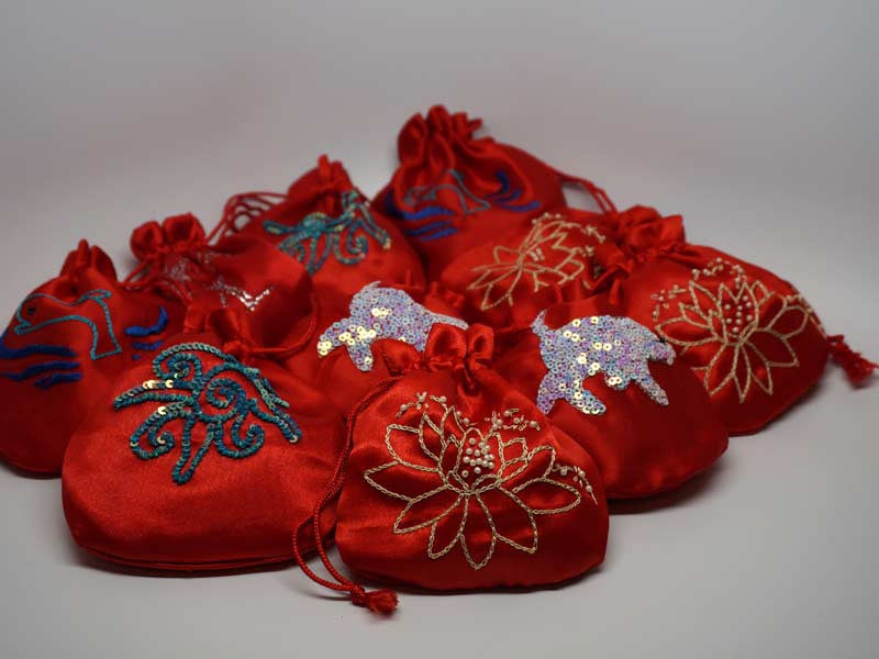 10 assorted red pouches with handmade embroidery