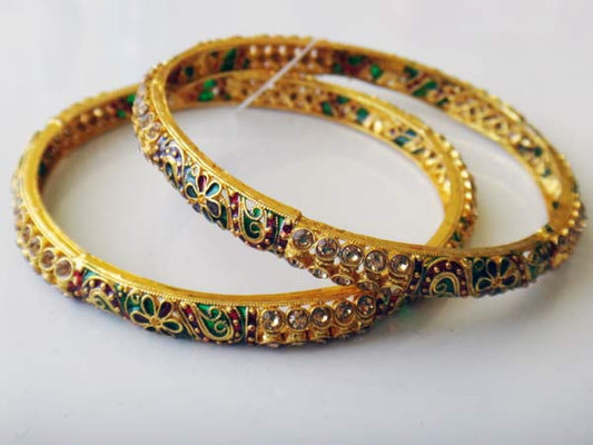 Golden bangles with stones